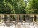 Outdoor deck featuring metal chairs and a table with views of the lush green trees at 5317 Deep Valley, Raleigh, NC 27606