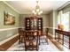Formal dining room showcasing a hardwood table, decorative china cabinet, and elegant chandelier at 5317 Deep Valley, Raleigh, NC 27606