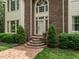 Charming front entrance with brick steps, landscaping, and a beautiful front door at 5317 Deep Valley, Raleigh, NC 27606