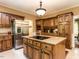Charming kitchen showcasing custom wood cabinets, granite countertops and a central island at 5317 Deep Valley, Raleigh, NC 27606
