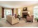 Inviting living room with a brick fireplace, large windows, and neutral color palette at 5317 Deep Valley, Raleigh, NC 27606