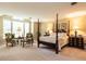 Bright main bedroom featuring four-poster bed, sitting area and large windows at 5317 Deep Valley, Raleigh, NC 27606