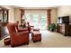 Comfortable sitting room with large French doors, red upholstered chairs, and wood dresser at 5317 Deep Valley, Raleigh, NC 27606
