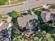Aerial view of the backyard featuring mature trees, a deck, and surrounding homes in a wooded neighborhood at 533 Opposition Way, Wake Forest, NC 27587