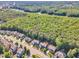 Scenic aerial view of a residential neighborhood nestled amidst dense green forests near a river at 533 Opposition Way, Wake Forest, NC 27587