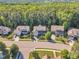 Neighborhood aerial view showing multiple homes in a wooded suburban setting at 533 Opposition Way, Wake Forest, NC 27587