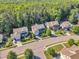 Aerial view of homes in a neighborhood with well-maintained landscaping and mature trees in a wooded setting at 533 Opposition Way, Wake Forest, NC 27587