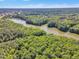 A landscape aerial view of green forest and a river on a partly cloudy day in a desirable area at 533 Opposition Way, Wake Forest, NC 27587
