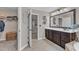 This bathroom features a closet, vanity with a framed mirror, soft neutral walls and tile flooring at 533 Opposition Way, Wake Forest, NC 27587