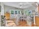 Bright dining area with large windows, hardwood floors, and an elegant table set at 533 Opposition Way, Wake Forest, NC 27587