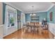 Elegant dining room with chandelier, wainscoting, and large window for natural light at 533 Opposition Way, Wake Forest, NC 27587