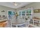 Bright dining area features a round table, wood floors, and natural light through large windows and sliding door at 533 Opposition Way, Wake Forest, NC 27587