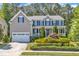 Charming two-story home with a well-manicured front yard and attached two-car garage at 533 Opposition Way, Wake Forest, NC 27587