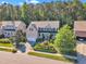 Aerial view of a two-story home with an attached garage and a beautifully landscaped front yard in a lovely neighborhood at 533 Opposition Way, Wake Forest, NC 27587