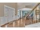 Bright foyer with hardwood floors and grand staircase, leading to the dining room at 533 Opposition Way, Wake Forest, NC 27587