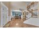 Bright foyer with hardwood floors, staircase, and open access to the dining room at 533 Opposition Way, Wake Forest, NC 27587