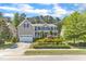 Charming two-story home featuring a well-manicured front yard, a covered front porch and attached garage at 533 Opposition Way, Wake Forest, NC 27587