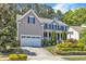 Charming two-story home featuring a well-manicured front yard, a covered front porch and attached garage at 533 Opposition Way, Wake Forest, NC 27587