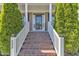 Welcoming front porch with brick steps and white railing leading to the front door at 533 Opposition Way, Wake Forest, NC 27587