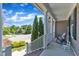 Inviting front porch with rocking chair and columns, overlooking a landscaped front yard at 533 Opposition Way, Wake Forest, NC 27587