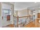 Upstairs hallway with hardwood floors, decorative molding, and views into other rooms at 533 Opposition Way, Wake Forest, NC 27587