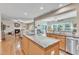 Modern kitchen with stainless steel appliances, granite countertops, and open layout to living room at 533 Opposition Way, Wake Forest, NC 27587