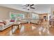 Bright living room with large windows, hardwood floors, and a comfortable sectional sofa at 533 Opposition Way, Wake Forest, NC 27587