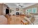 Open-concept living room with hardwood floors, fireplace, and entertainment center at 533 Opposition Way, Wake Forest, NC 27587
