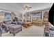 This expansive living room offers plush seating, a ceiling fan and carpet flooring at 533 Opposition Way, Wake Forest, NC 27587