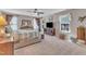 Spacious main bedroom with windows, ceiling fan, carpeted floor, and stylish furnishings at 533 Opposition Way, Wake Forest, NC 27587
