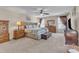 Bright main bedroom boasts plush carpeting, ceiling fan, two dressers and large windows at 533 Opposition Way, Wake Forest, NC 27587