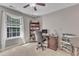 Well-lit office space with a dark wood desk, carpet, and a ceiling fan at 533 Opposition Way, Wake Forest, NC 27587