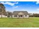 Rear exterior showing large backyard and covered porch at 56 Birchtop Cir, Zebulon, NC 27597