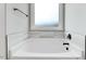 Close up of a soaking tub with tile surround in the bathroom at 56 Birchtop Cir, Zebulon, NC 27597
