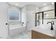 Bathroom with double sink vanity, soaking tub and walk-in shower with tile surround at 56 Birchtop Cir, Zebulon, NC 27597