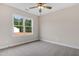 Bedroom with window overlooking the yard, carpet flooring, and neutral paint at 56 Birchtop Cir, Zebulon, NC 27597