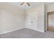 Neutral bedroom featuring carpet flooring, a ceiling fan, and a closet with white bi-fold doors at 56 Birchtop Cir, Zebulon, NC 27597