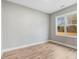 This bedroom boasts a large window and wood-look flooring at 56 Birchtop Cir, Zebulon, NC 27597