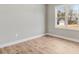 This bedroom features wood-look flooring and a view of the detached garage at 56 Birchtop Cir, Zebulon, NC 27597