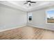 Large bedroom with wood floors and two windows providing natural light at 56 Birchtop Cir, Zebulon, NC 27597