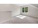 Bonus room featuring carpet flooring, a window with a view, and natural light at 56 Birchtop Cir, Zebulon, NC 27597