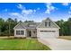 Inviting home exterior boasts a well-maintained lawn, attractive curb appeal, and an attached garage at 56 Birchtop Cir, Zebulon, NC 27597