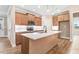 This kitchen offers an island, stainless appliances, and wood-style flooring at 56 Birchtop Cir, Zebulon, NC 27597