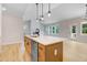Open concept kitchen showcases an island with pendant lights and views to Gathering room at 56 Birchtop Cir, Zebulon, NC 27597