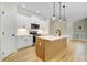 Modern kitchen features an island, pendant lights, and stainless steel appliances at 56 Birchtop Cir, Zebulon, NC 27597