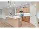 Well-lit kitchen features an island, stainless appliances, and wood-style flooring at 56 Birchtop Cir, Zebulon, NC 27597