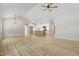 Bright, open-concept living space featuring wood-look flooring and a view into the kitchen at 56 Birchtop Cir, Zebulon, NC 27597