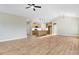 Open concept living space flowing into the kitchen with hardwood flooring at 56 Birchtop Cir, Zebulon, NC 27597