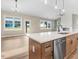 This living room and kitchen area includes wood-style floors and lots of windows at 56 Birchtop Cir, Zebulon, NC 27597