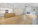 Open concept living space with a kitchen island, fireplace, and wood-look flooring at 56 Birchtop Cir, Zebulon, NC 27597